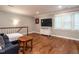 Bright living room features hardwood floors, a flat screen TV, and a baseball jersey hanging on the wall at 104 Warley Cir, Cary, NC 27513