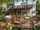 Expansive two-story home with multilevel decks and stairs leading down to the wooded area at 104 Warley Cir, Cary, NC 27513