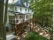 Two-story home showcasing extensive rear decks and screened porch overlooking the wooded backyard at 104 Warley Cir, Cary, NC 27513