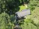 Stunning aerial view of home surrounded by mature trees and green lawn at 10625 Soma Ct, Raleigh, NC 27613