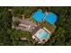 Aerial view of the community pool and tennis courts surrounded by lush greenery at 10625 Soma Ct, Raleigh, NC 27613