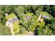 Aerial view showcases a home surrounded by lush trees and greenery at 10625 Soma Ct, Raleigh, NC 27613