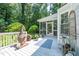 A home's deck featuring an outdoor grill, a chiminea, a blue rug, and a view to the sun room at 10625 Soma Ct, Raleigh, NC 27613