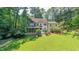 A home's backyard featuring a lush lawn, patio, and sunroom at 10625 Soma Ct, Raleigh, NC 27613