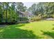 A home's backyard featuring a lush lawn, patio, and sunroom at 10625 Soma Ct, Raleigh, NC 27613