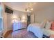 A bright bedroom with colorful accents, hardwood floors, and a whimsical chandelier at 10625 Soma Ct, Raleigh, NC 27613