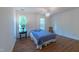 Minimalist bedroom with hardwood floors and neutral tones, filled with soft natural light at 10625 Soma Ct, Raleigh, NC 27613