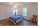 Cozy bedroom with hardwood floors, abundant natural light and soft blue bedding at 10625 Soma Ct, Raleigh, NC 27613