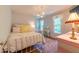 Charming bedroom with a metal frame bed, bright decor, and a vanity illuminated by natural light at 10625 Soma Ct, Raleigh, NC 27613