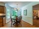 Cozy breakfast nook with a bay window, hardwood floors, and views of the lush backyard at 10625 Soma Ct, Raleigh, NC 27613