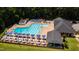 A view of the community pool with lounge chairs and tables with umbrellas at 10625 Soma Ct, Raleigh, NC 27613