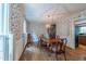 Formal dining room with a wood table, wood floors, and decorative wallpaper at 10625 Soma Ct, Raleigh, NC 27613