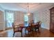 Dining room boasts hardwood floors, crown molding, and a classic chandelier above wood table at 10625 Soma Ct, Raleigh, NC 27613