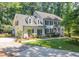 Charming two-story home with a well-manicured lawn, lush landscaping, and a welcoming front porch at 10625 Soma Ct, Raleigh, NC 27613
