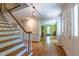 Inviting foyer with hardwood floors, staircase, and an open view to the adjacent living room at 10625 Soma Ct, Raleigh, NC 27613