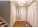 Classic home hallway featuring hardwood floors, decorative light fixture and multiple doorways at 10625 Soma Ct, Raleigh, NC 27613