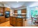 Sunlit kitchen with an island, breakfast nook, and lots of cabinet space with wood finish at 10625 Soma Ct, Raleigh, NC 27613