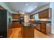 Traditional kitchen featuring wood cabinets, black granite countertops, stainless steel appliances, and hardwood floors at 10625 Soma Ct, Raleigh, NC 27613