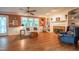 Warm living room with built-in bookshelves, fireplace, hardwood floors, and a ceiling fan at 10625 Soma Ct, Raleigh, NC 27613