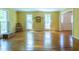 Spacious living room with hardwood floors, large windows, and natural light at 10625 Soma Ct, Raleigh, NC 27613