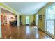 Living room with wood floors, light yellow walls, large windows, and an open layout at 10625 Soma Ct, Raleigh, NC 27613