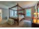 Spacious main bedroom featuring a four poster bed, neutral colors, and carpeted floors at 10625 Soma Ct, Raleigh, NC 27613
