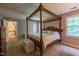A large main bedroom featuring a four poster bed, neutral colors, and carpeted floors at 10625 Soma Ct, Raleigh, NC 27613