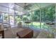 Inviting screened porch featuring multiple ceiling fans and comfortable seating, ideal for outdoor relaxation at 10625 Soma Ct, Raleigh, NC 27613