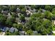 Wide aerial view showcasing a neighborhood filled with mature trees at 107 Quarter Path, Cary, NC 27518
