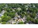Wide aerial view showcasing a neighborhood filled with mature trees at 107 Quarter Path, Cary, NC 27518