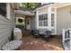 Charming back patio with brick flooring, outdoor seating, and lush landscaping at 107 Quarter Path, Cary, NC 27518