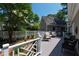 Spacious backyard deck with white railing, shaded by mature trees, offers a serene outdoor space at 107 Quarter Path, Cary, NC 27518