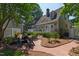 Inviting backyard with a patio, outdoor seating, lush greenery, and an attached garage at 107 Quarter Path, Cary, NC 27518