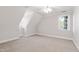 Upstairs bedroom with carpet, angled ceiling, and natural light at 107 Quarter Path, Cary, NC 27518