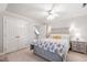 Well-lit bedroom features neutral walls, a ceiling fan, and an adjoining bathroom at 107 Quarter Path, Cary, NC 27518