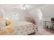Bright bedroom featuring slanted ceilings, large bed and desk area by the window at 107 Quarter Path, Cary, NC 27518