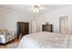 Bright bedroom with an armchair, hardwood floors, and natural light, creating a cozy and welcoming atmosphere at 107 Quarter Path, Cary, NC 27518
