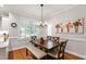Dining room with chandelier, shutters, and view of the kitchen at 107 Quarter Path, Cary, NC 27518