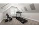 Bright exercise room with sloped ceilings, a treadmill and weight bench for your fitness needs at 107 Quarter Path, Cary, NC 27518