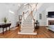 Grand foyer featuring a staircase with carpeted treads, hardwood floors, and a bright, open feel at 107 Quarter Path, Cary, NC 27518