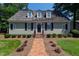 Charming single-story home with a brick walkway, manicured landscaping, and dormer windows at 107 Quarter Path, Cary, NC 27518