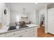 Bright eat-in kitchen features white cabinets, granite countertops, and stainless steel appliances at 107 Quarter Path, Cary, NC 27518