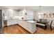 Eat-in kitchen with granite countertops, an island, white cabinets, and stainless steel appliances at 107 Quarter Path, Cary, NC 27518