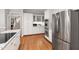 Gourmet kitchen with granite counters, wine storage, stainless appliances, and hardwood floors at 107 Quarter Path, Cary, NC 27518