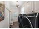 Laundry room featuring modern washer and dryer, and lots of cabinets at 107 Quarter Path, Cary, NC 27518