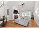 Spacious living room featuring hardwood floors, a fireplace, large windows, and comfortable seating at 107 Quarter Path, Cary, NC 27518