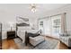 Bright and airy main bedroom with large windows, a ceiling fan, and a neutral color scheme at 107 Quarter Path, Cary, NC 27518