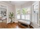 Bright sitting area with hardwood floors, a comfortable bench by the windows, and access to the living room at 107 Quarter Path, Cary, NC 27518