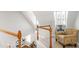 Upper-level staircase with wood railings, carpeted steps, and a decorative chair on the landing at 107 Quarter Path, Cary, NC 27518