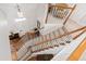 Elegant staircase with carpeted steps, wooden railings, and a clear view of the front entrance at 107 Quarter Path, Cary, NC 27518